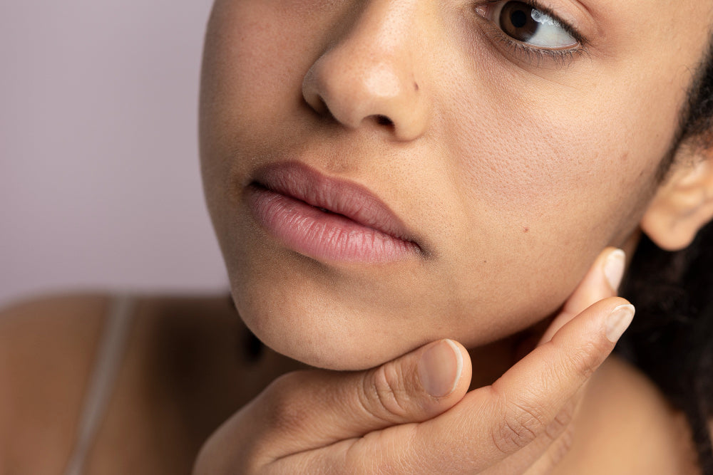 Close-up of woman's face showing dull uneven skin