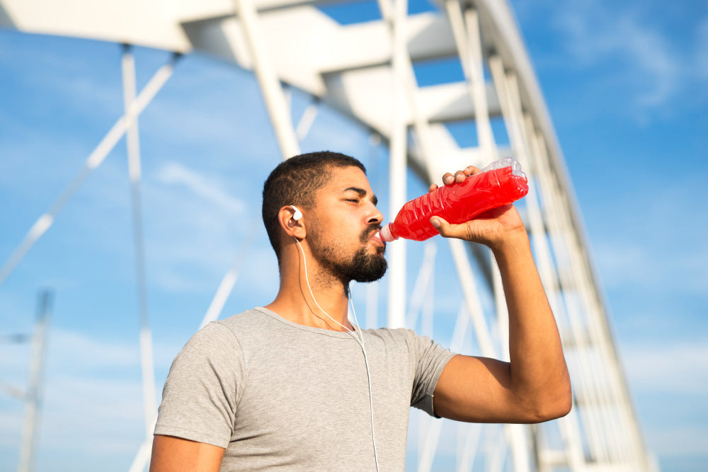 Man drinking an electrolyte beverage after exercise