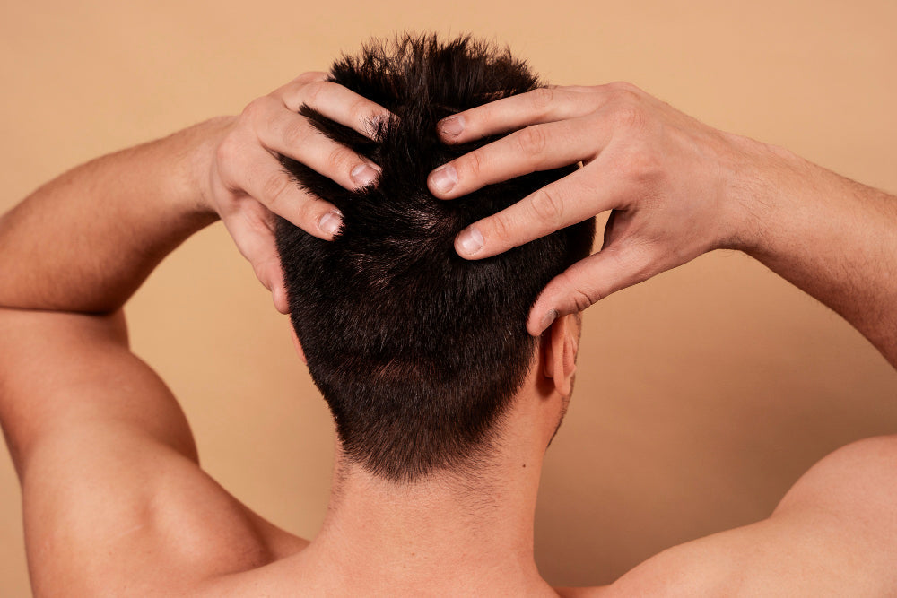 Man touching an irritated scalp