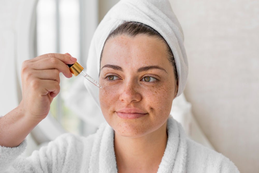 Woman applying jojoba oil serum to acne-prone skin