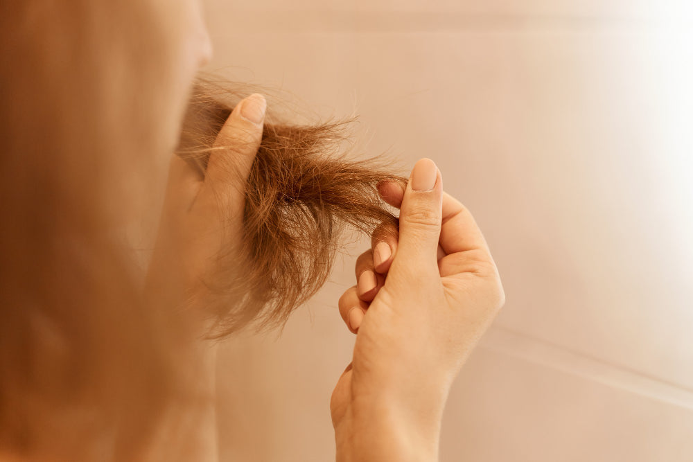 Woman checking hair loss from stress