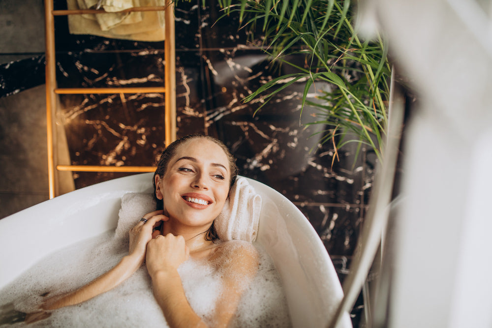 Woman relaxing in a warm bath at home