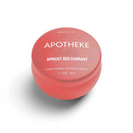 A mini tin candle in apricot red currant scent with pink packaging 