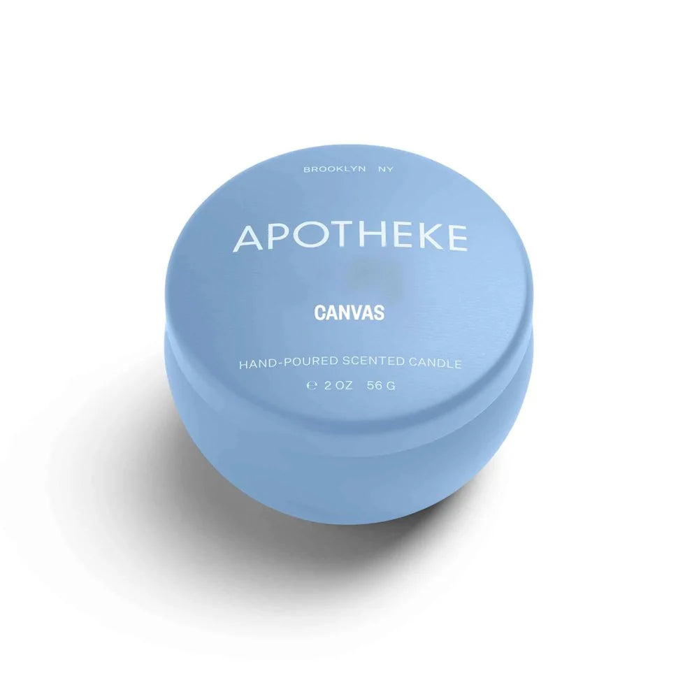 A mini tin candle in canvas scent with blue packaging 