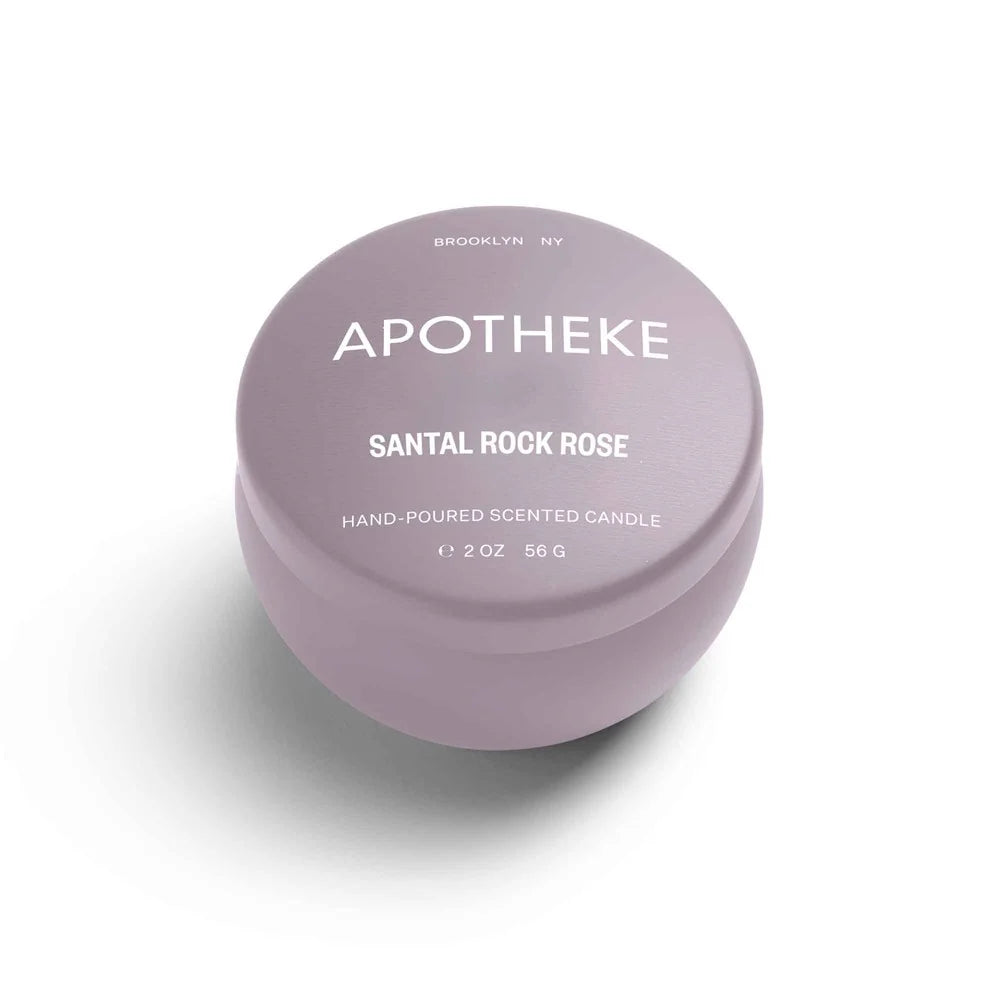A mini tin candle in santal rock rose scent with lilac packaging 