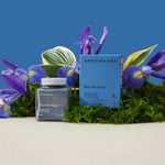 A jar of blue me away supplement with a background of plants