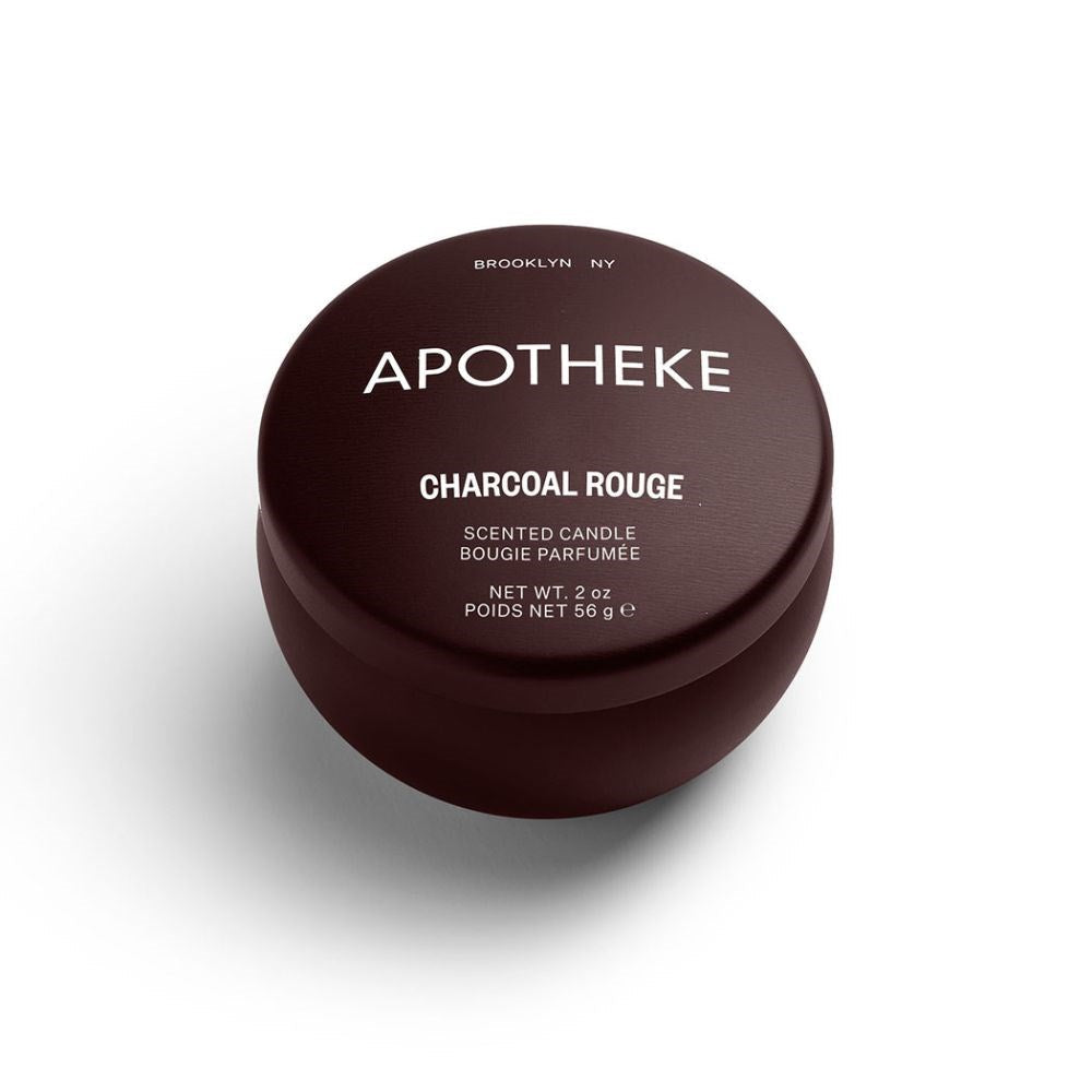 A mini tin candle in charcoul rouge scent with burgundy packaging 