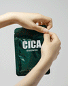 Animated GIF showing hands gently unfolding a CICA sheet facial mask, demonstrating the product texture and application process