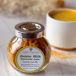 Jar of Golden Milk Turmeric Latte mix with a cup of latte in the background