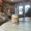 Good Life Box by Campus Rebel - colorful tin candle with retro VW bus "Peace On The Beach" design displayed on a wooden surface in a boutique store setting