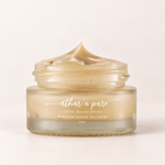 A glass jar of Athar'a Pure Moroccan Coffee Eye Cream with a swirled cream texture visible inside and on top of the open jar