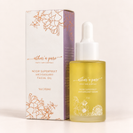 A 1 oz bottle of aethar a Facial Oil next to its white and lavender packaging box with copper line art