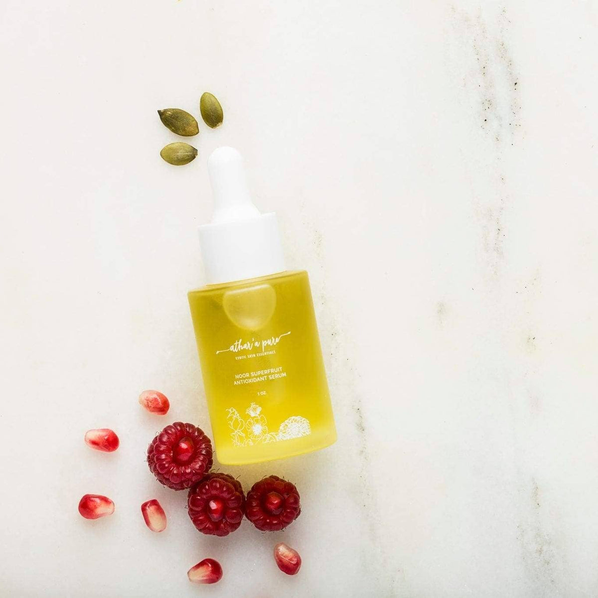 A bottle of golden-yellow skincare serum with a white dropper cap