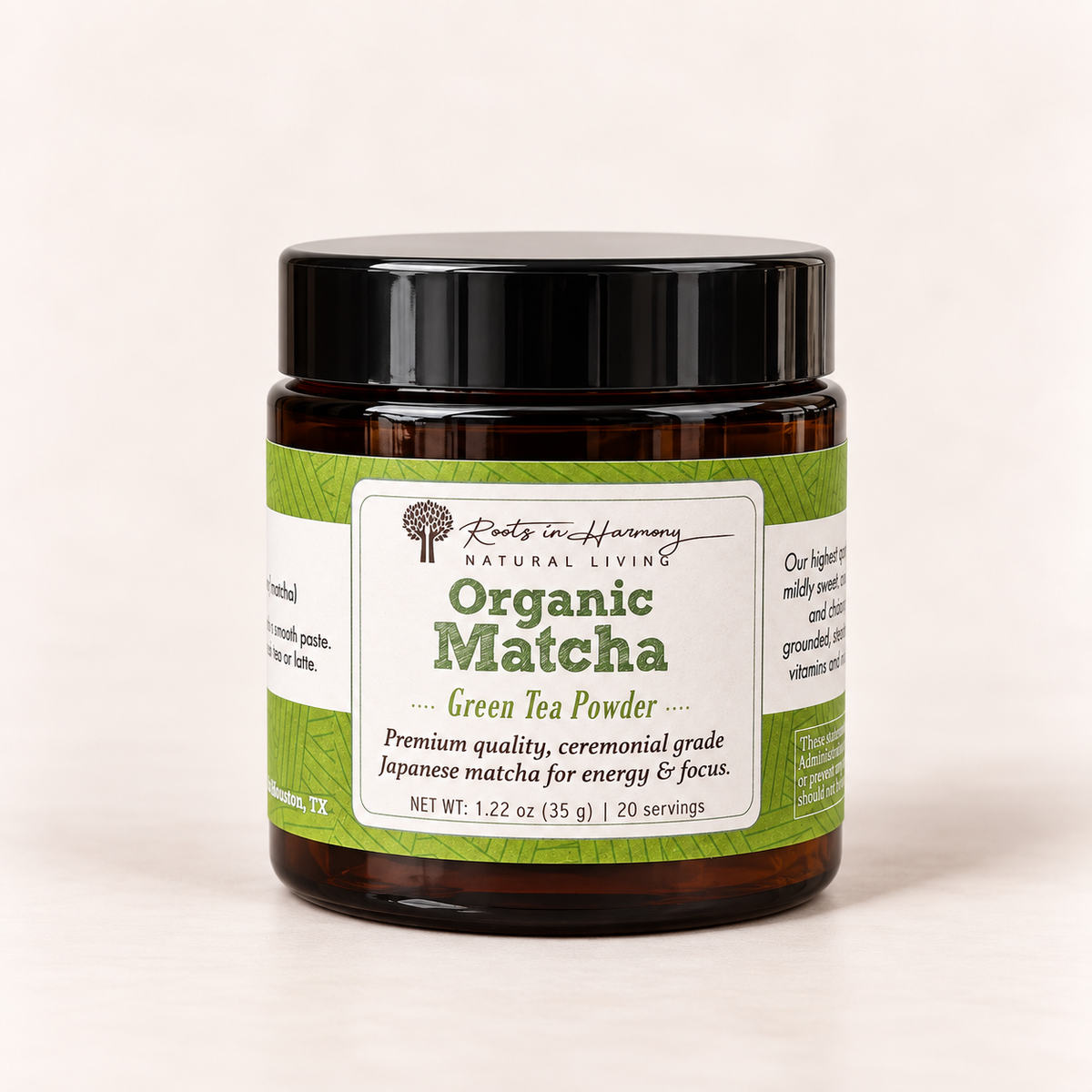 A jar of Roots in Harmony Natural Living Organic Matcha Green Tea Powder, in an amber glass jar with a black lid and a green and white label, set against a plain off-white background.