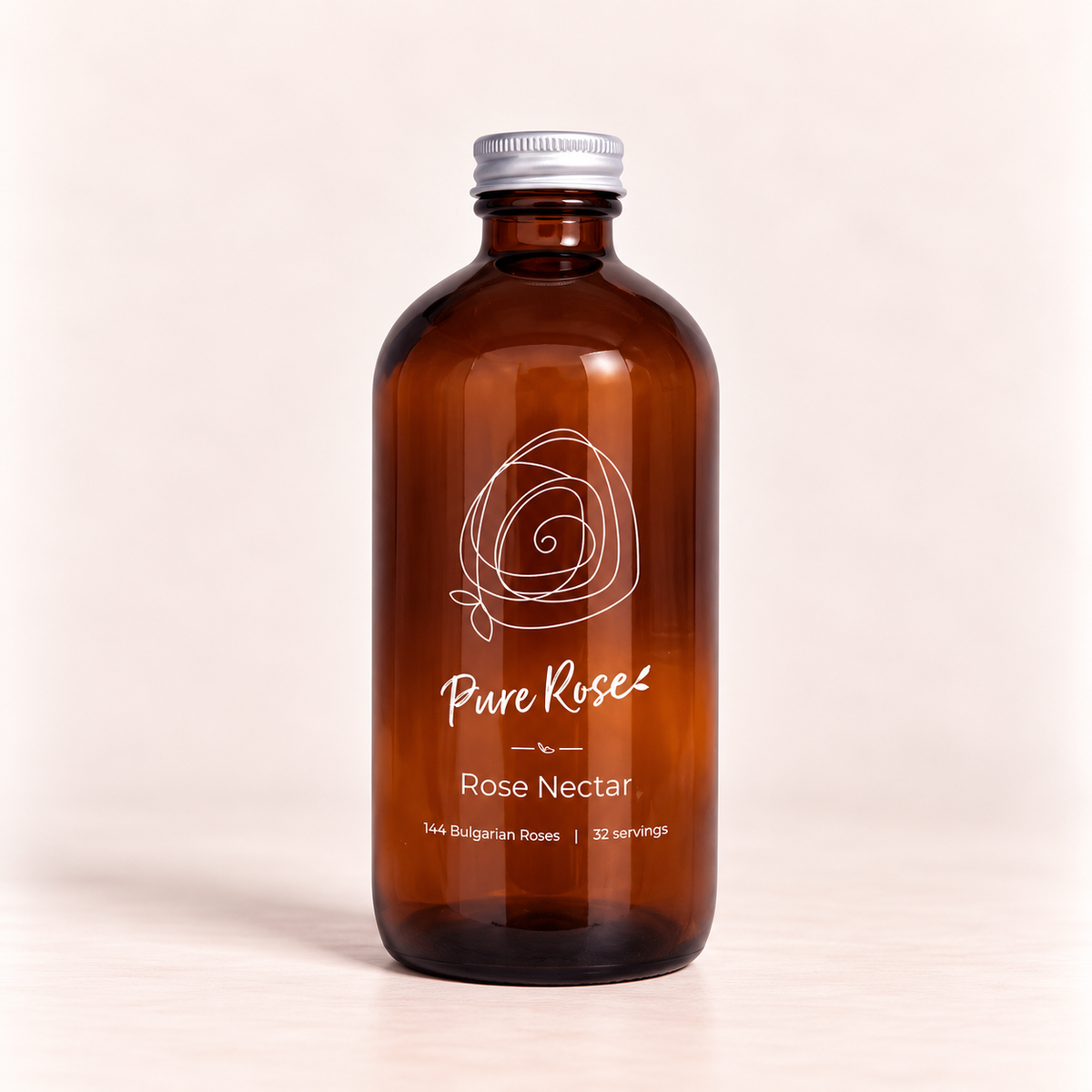 An amber glass bottle of Pure Rose Rose Nectar with a silver metal cap, set against a clean, light beige background.