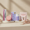 The Menopause Collection featuring Superieur strips, Apotheke Sea Salt Grapefruit balm tin, Womaness Me No Pause vitamins, and MicroJoy Motivate mushroom gummies arranged on platforms with ribbon on neutral background