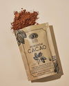 Anima Mundi Heirloom Cacao pouch spilling cacao powder, showcasing nutrient-dense single-origin Ecuadorian cacao