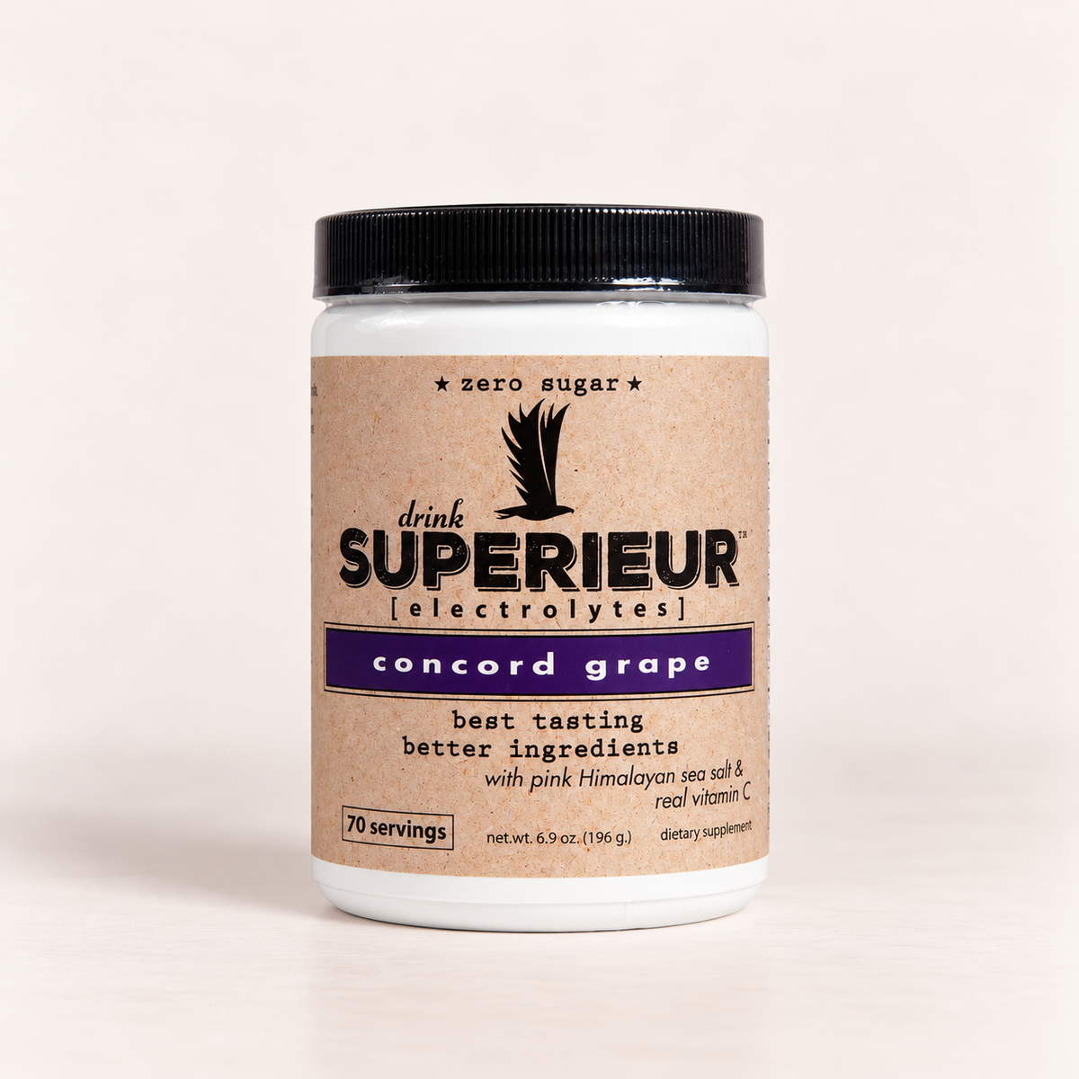 A white plastic jar of drink SUPERIEUR [electrolytes] Concord Grape flavor, featuring a kraft paper label with a purple band 
