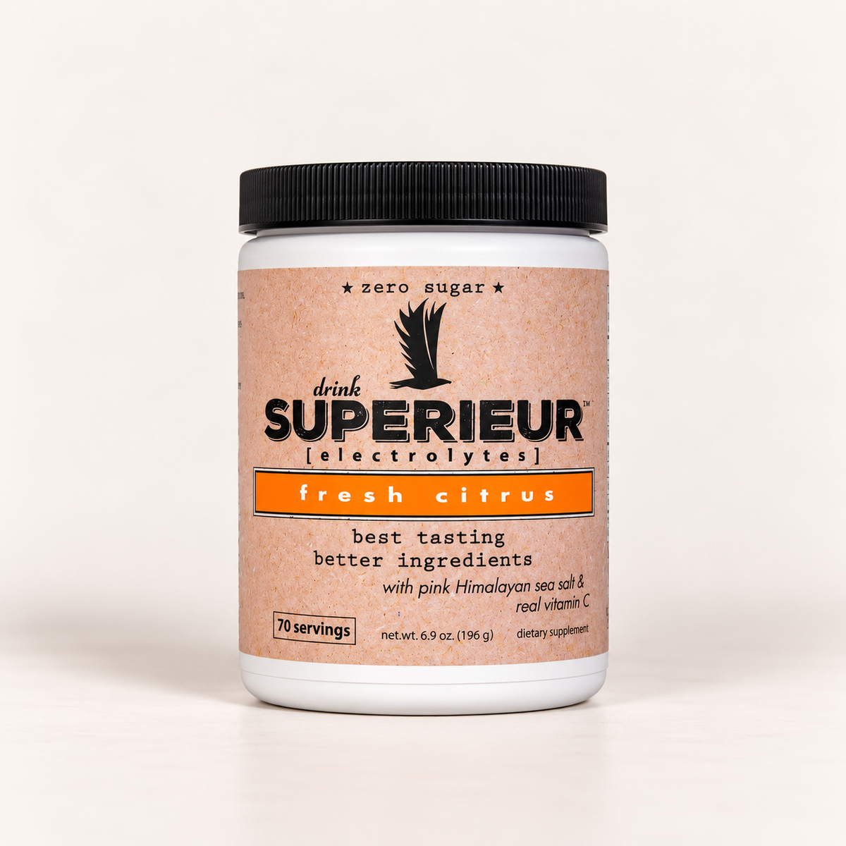 A white plastic tub of drink SUPERIEUR [electrolytes] in fresh citrus flavor, featuring a black ribbed lid and a textured peach-colored label with orange and black text.