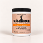 A white plastic tub of drink SUPERIEUR [electrolytes] in fresh citrus flavor, featuring a black ribbed lid and a textured peach-colored label with orange and black text.