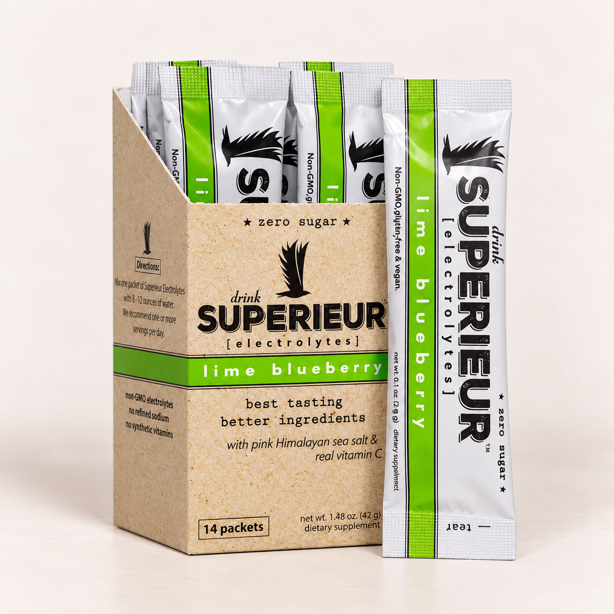 A box of Drink Superior Electrolytes lime blueberry packets stands next to a single individual packet on a clean, light beige background