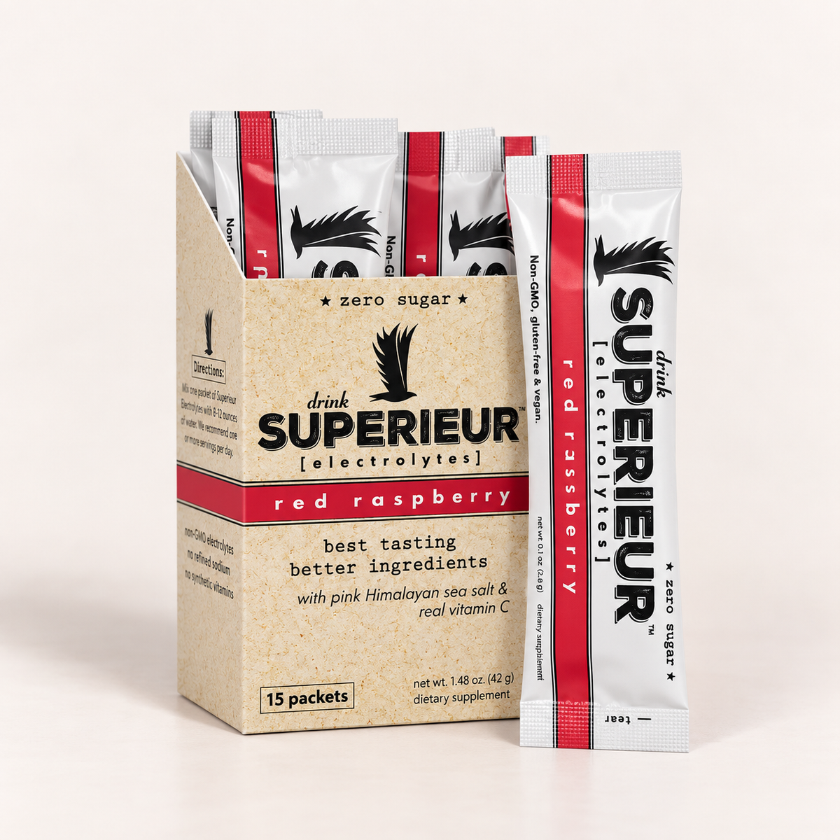 A box of Drink Superieur Red Raspberry electrolyte packets with several individual packets standing in front